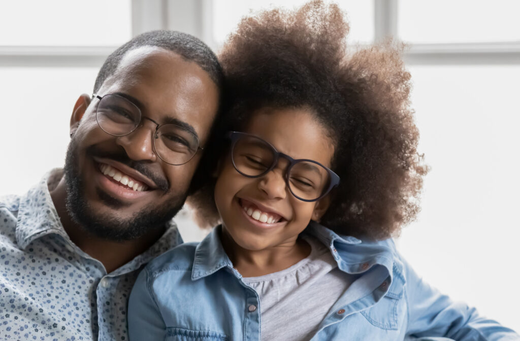 Man and child wearing eyeglasses smiling