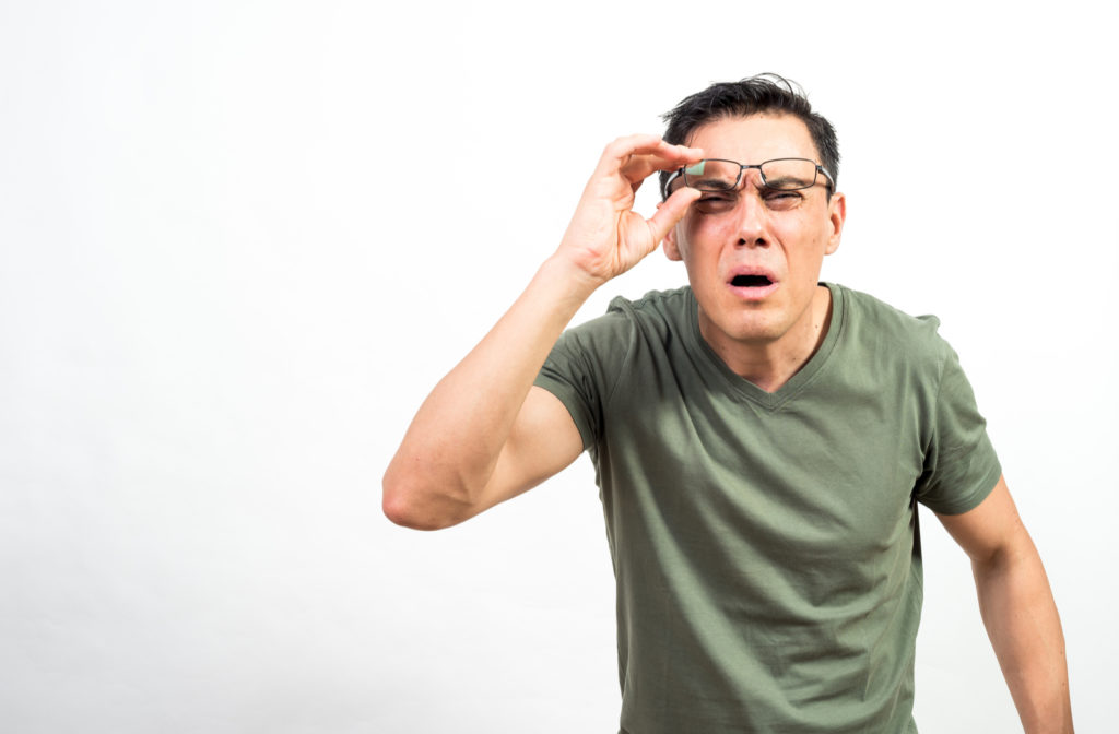 Man squinting eyes to see far distance due to myopia