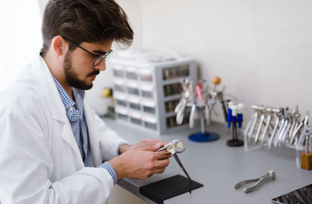 An optician fixing and repairing eyeglasses