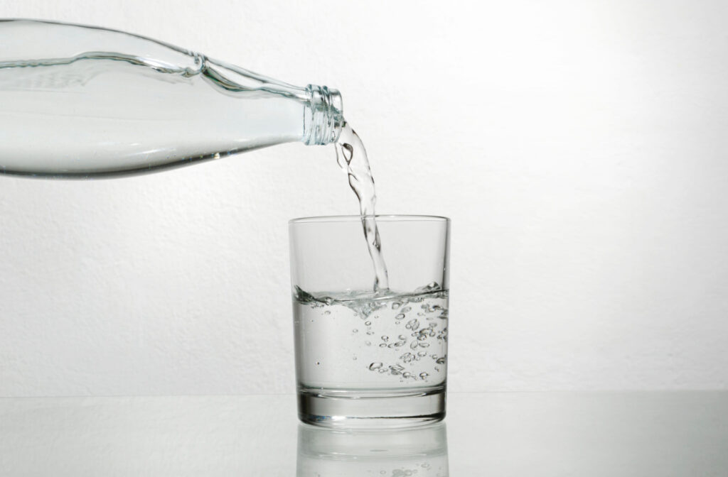 Water being poured from a bottle into a glass