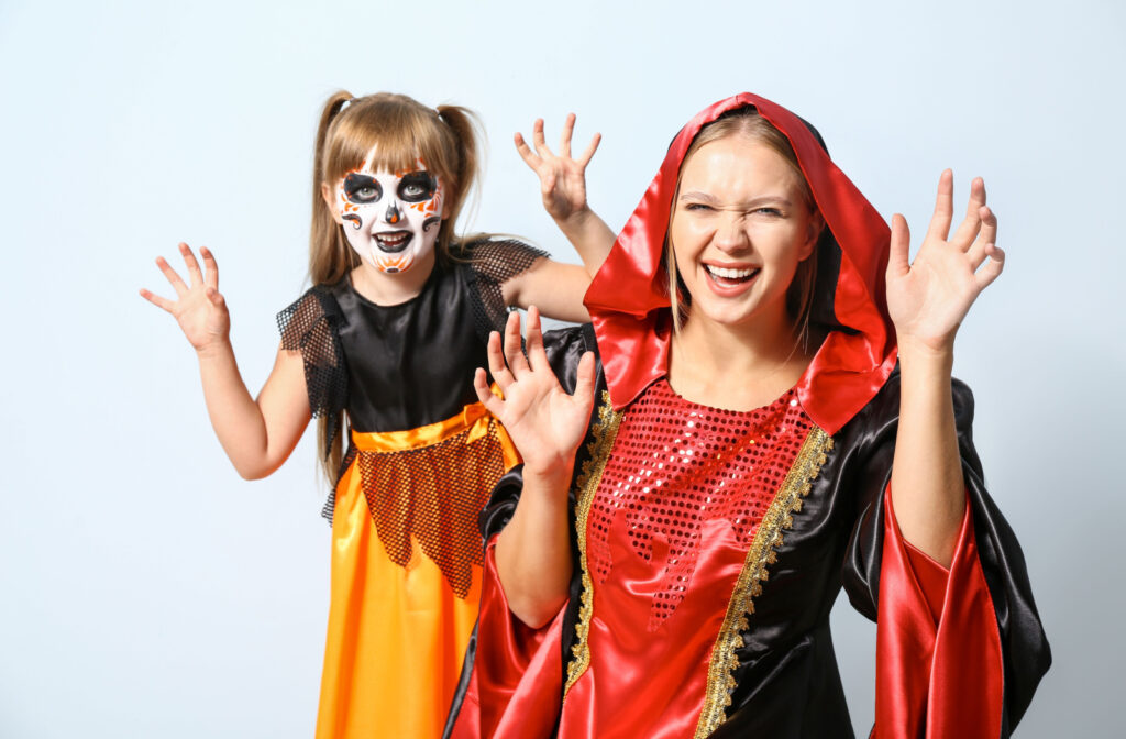 Woman and child in Halloween costumes