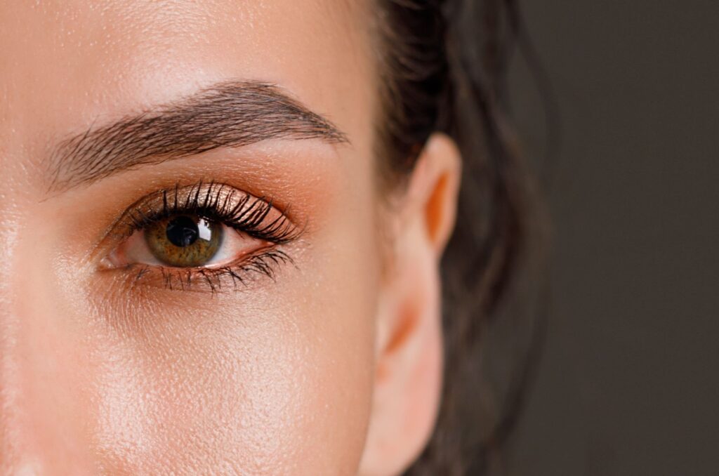 A close-up image of a person's left eye showing redness from dry eyes.