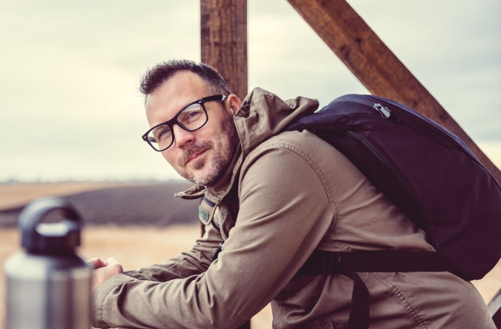 Person with an active lifestyle wearing glasses outdoors on a hike.