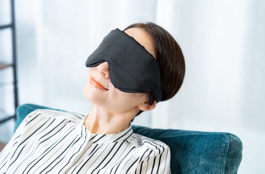 A person wearing an eye mask to soothe their dry eyes