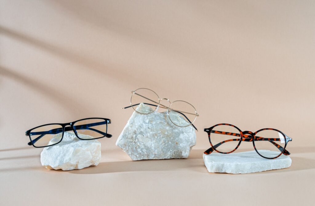 Three pairs of glasses sitting on white rocks